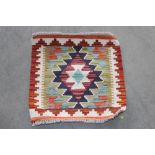 An approx. 1'5" x 1'5" Chobi Kelim rug