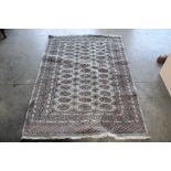 An approx. 6'3" x 4'2" green pattern rug