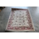 An approx. 5'2" x 4" red and cream pattern rug