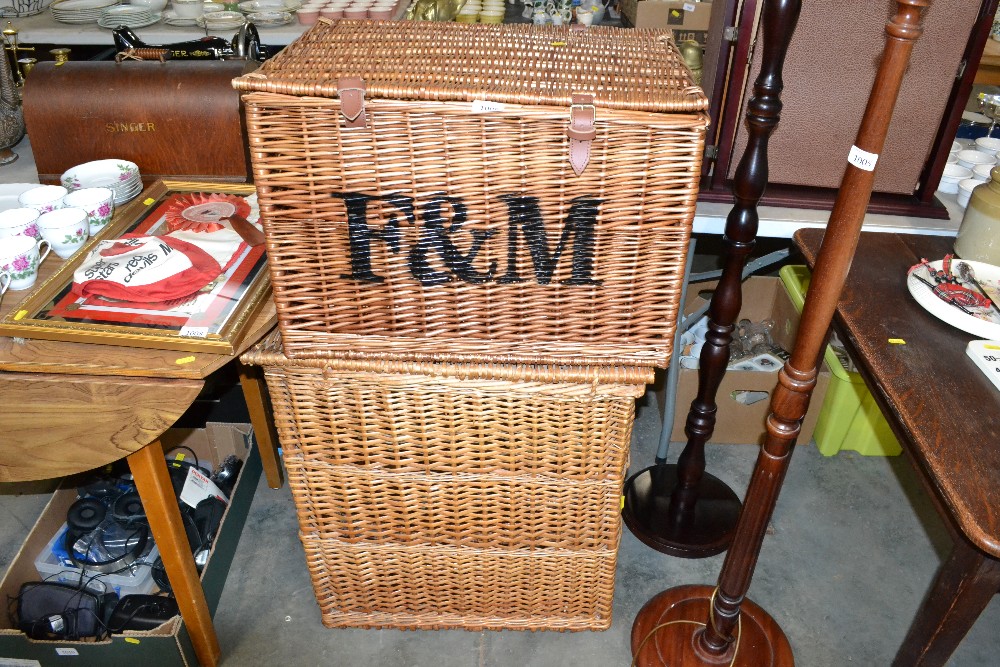 A Fortnum and Mason picnic basket and a wicker lau