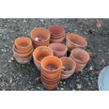 A quantity of small terracota pots