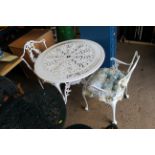 An ornate white painted bistro set