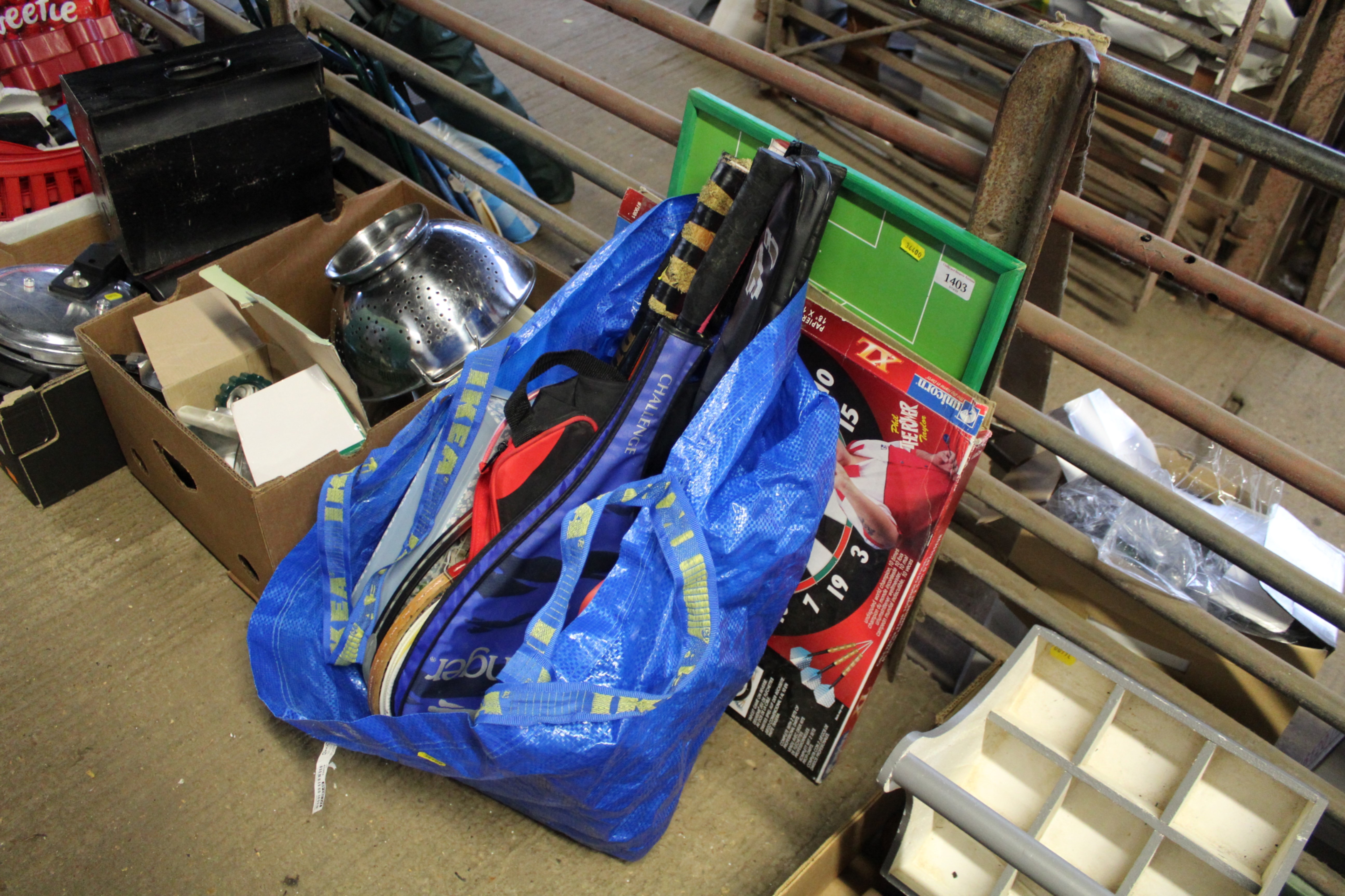 A bag of various rackets, dart board etc