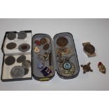 A box containing various tokens, badges, St John's