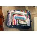 A bag containing a crochet blanket etc.