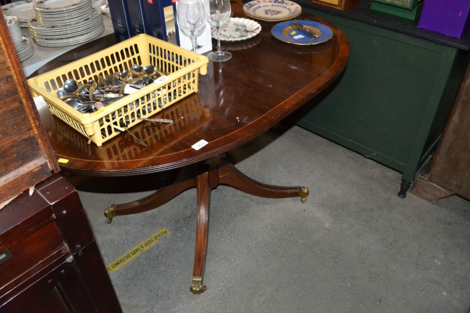 A reproduction mahogany oval dining table