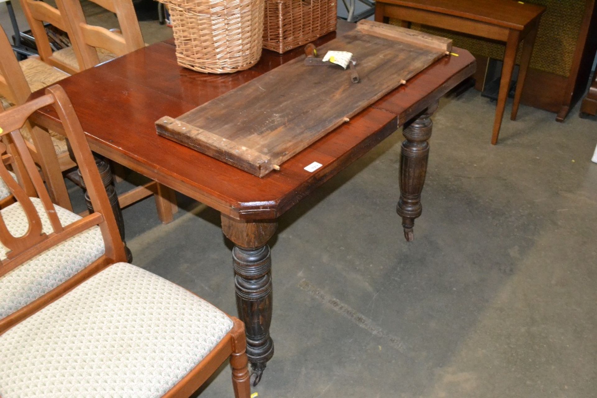 A late Victorian extending dining table with extra