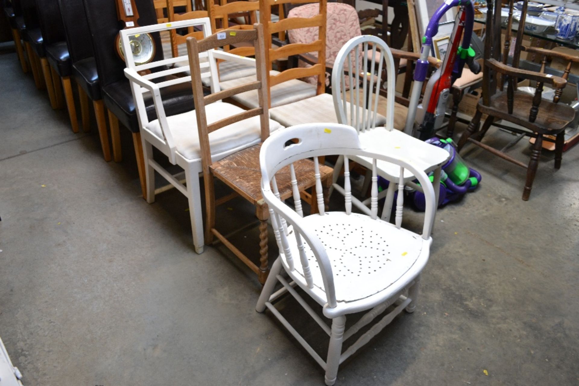 A white painted spindle back tub chair; a rush sea