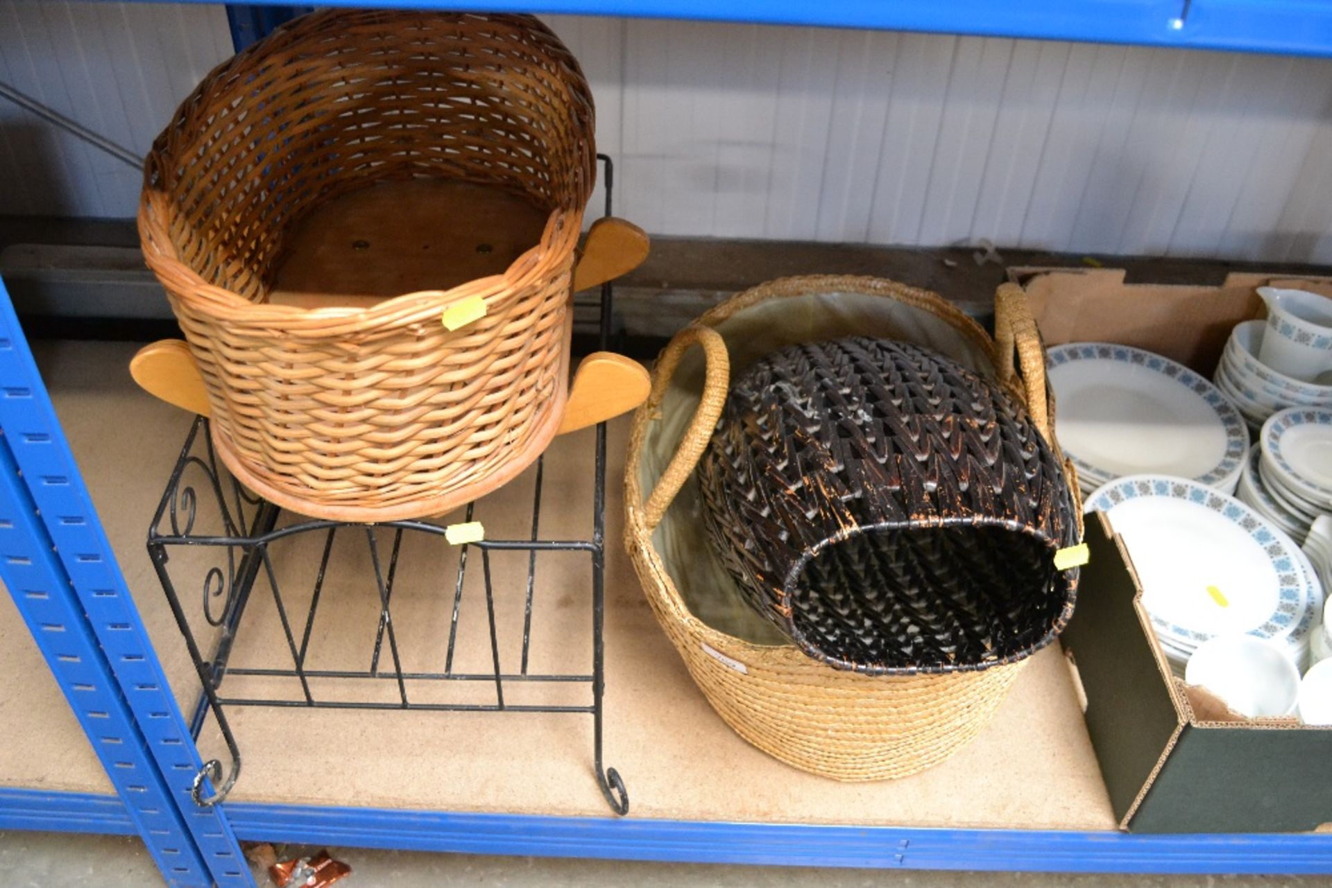 A wicker crib; a cot together with a vase