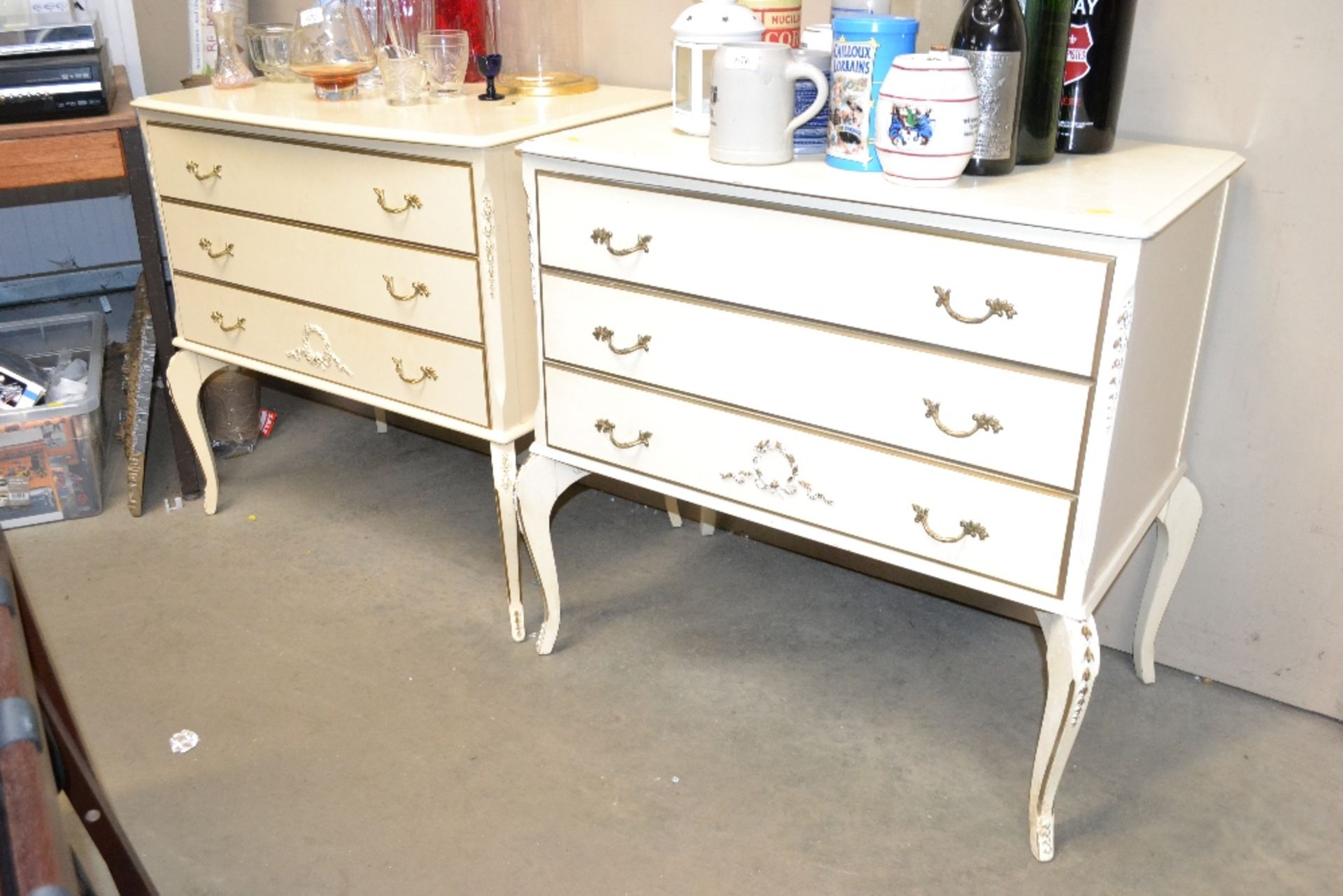 Two cream and gilt decorated three drawer chests