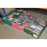 Three boxes containing various CDs and books
