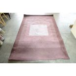 An aprox 7'6" x 4'8" brown patterned rug