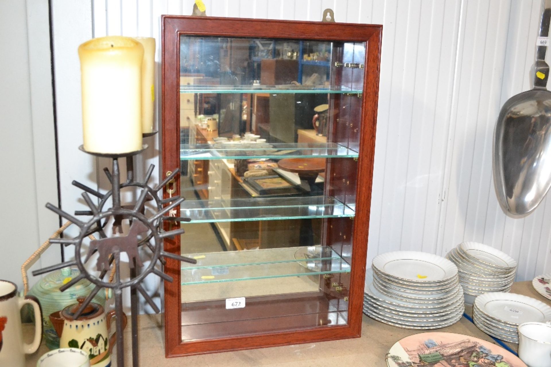 A wall mounted display case with key