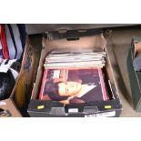 A box containing various LPs