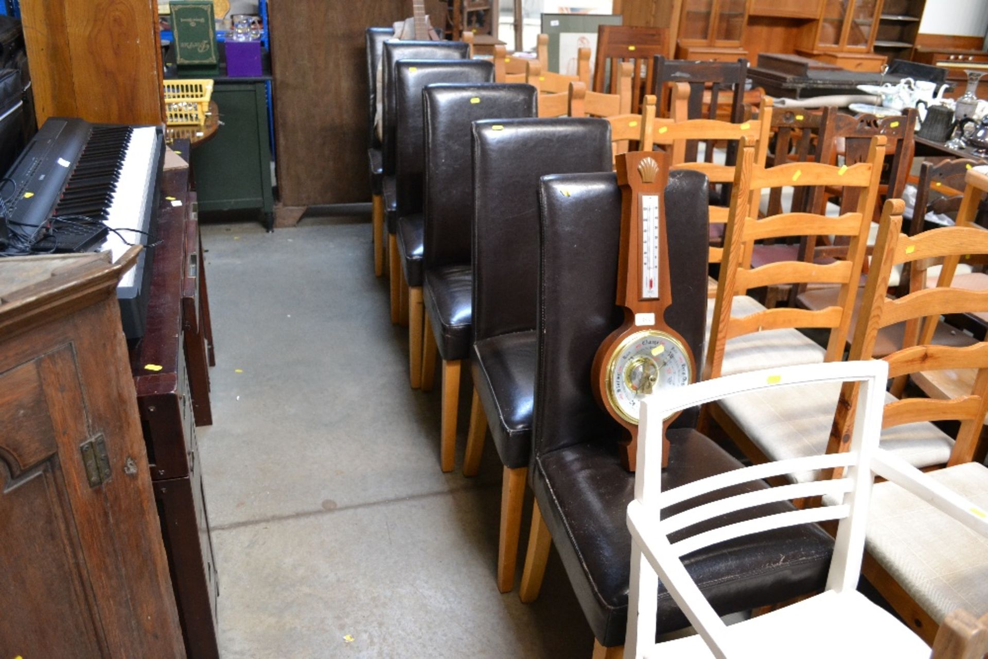 Six faux brown leather upholstered dining chairs