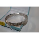 A Sterling silver hand planished hinged bangle