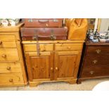 A Ducal pine side cupboard fitted two drawers