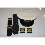 A Royal Naval Officers hat with epaulettes and tie