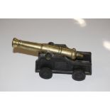 A brass and cast metal cannon