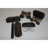 A box containing opera glasses and spectacles