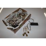 A box containing various beaded costume necklaces,