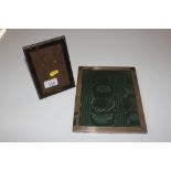 A silver photo frame together with a white metal a