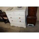 A white painted pine chest fitted two short over t