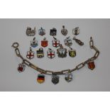 A silver charm bracelet and several silver and ena