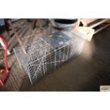 A galvanised metal rabbit trap