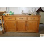 A modern light oak sideboard fitted three drawers