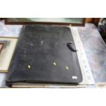 A large folio containing various art prints and po