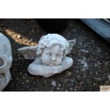 A concrete ornament in the form of a cherub and an