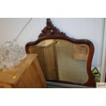 A carved mahogany framed and bevelled edge mirror