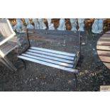 A metal and wooden slatted garden seat