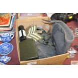 A box of militaria including cloth badges, gun cle