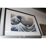 An Oriental print depicting boats in heavy seas