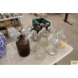 Ten demi johns and a glass pouring jar