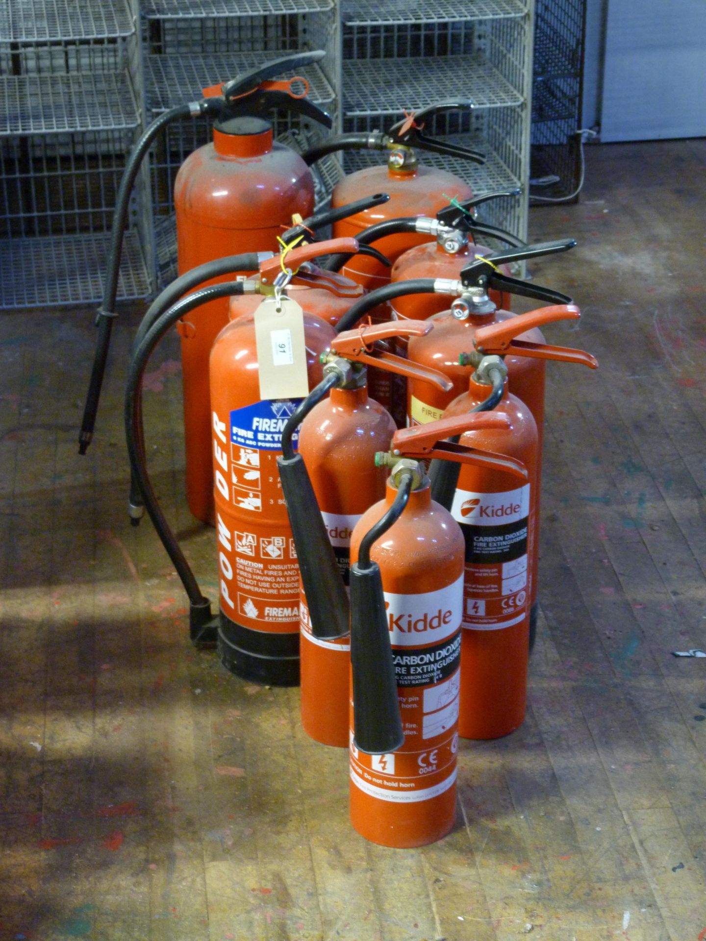 Nine various fire extinguishers