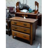 A small dresser style unit with ornate back
