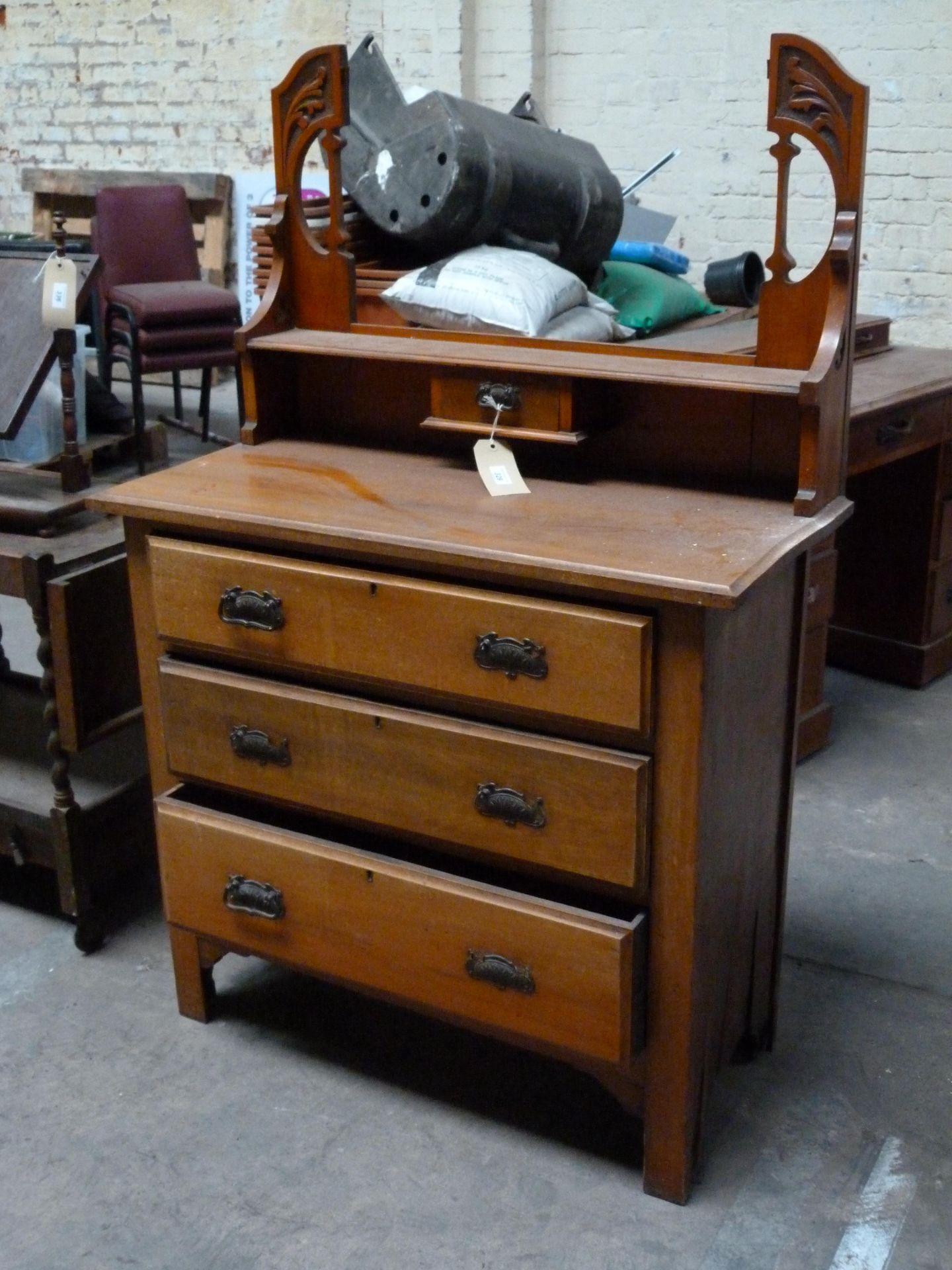 A small dresser style unit with ornate back