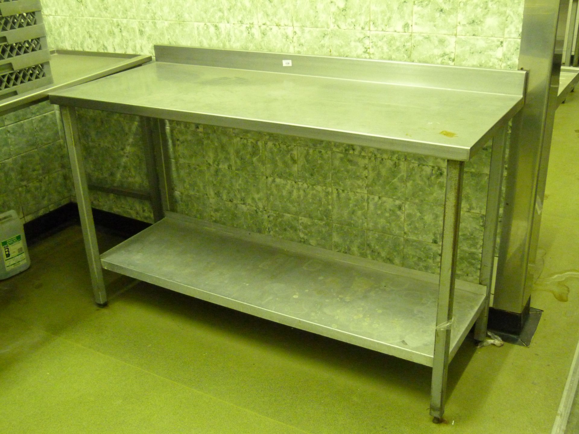 A steel framed stainless steel topped preparation table with shelf 153cm x 62cm