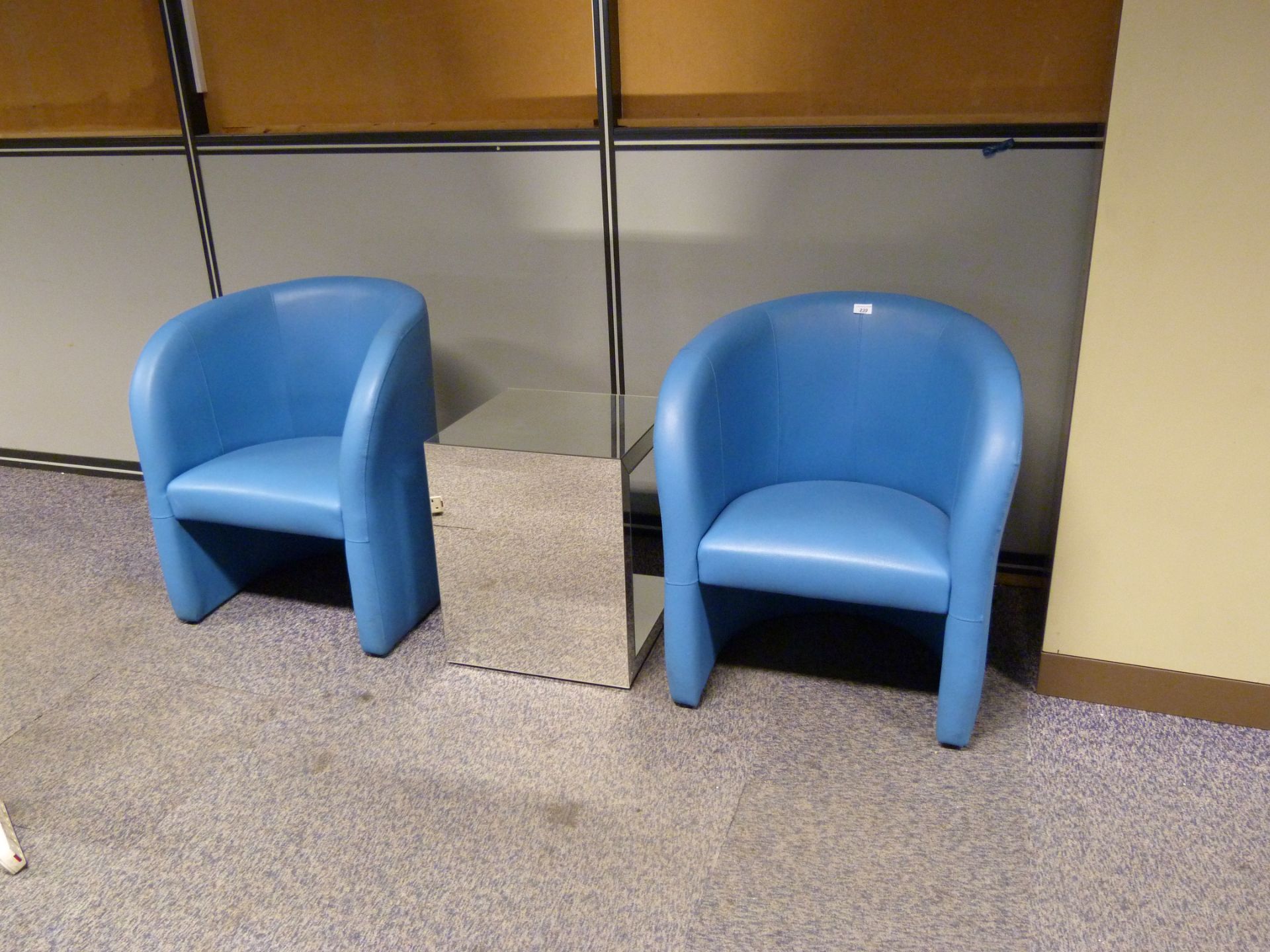 Two matching blue tub chairs plus small mirrored coffee table