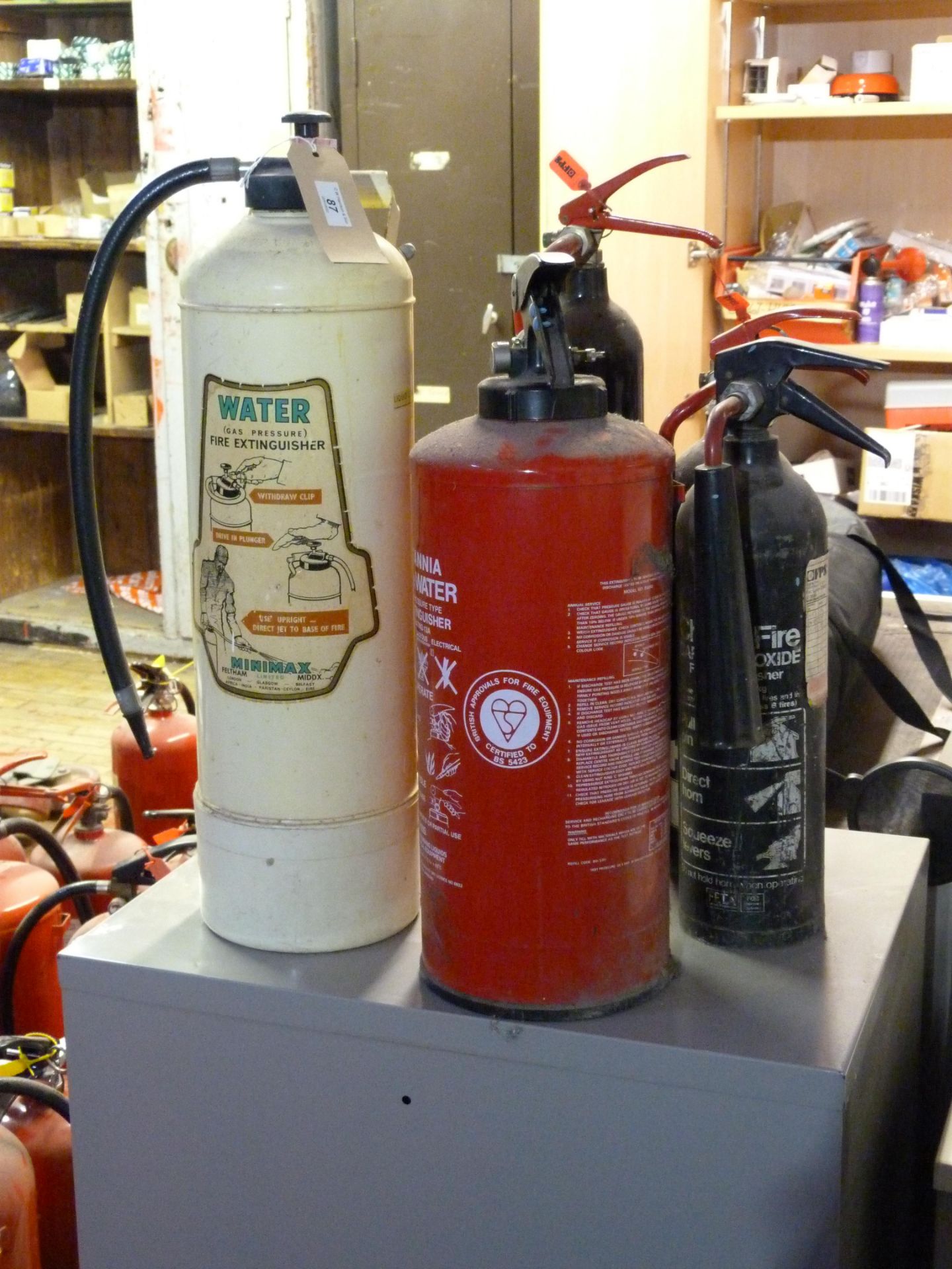Five various old fire extinguishers
