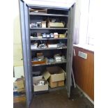 A grey metal double door cupboard and contents,