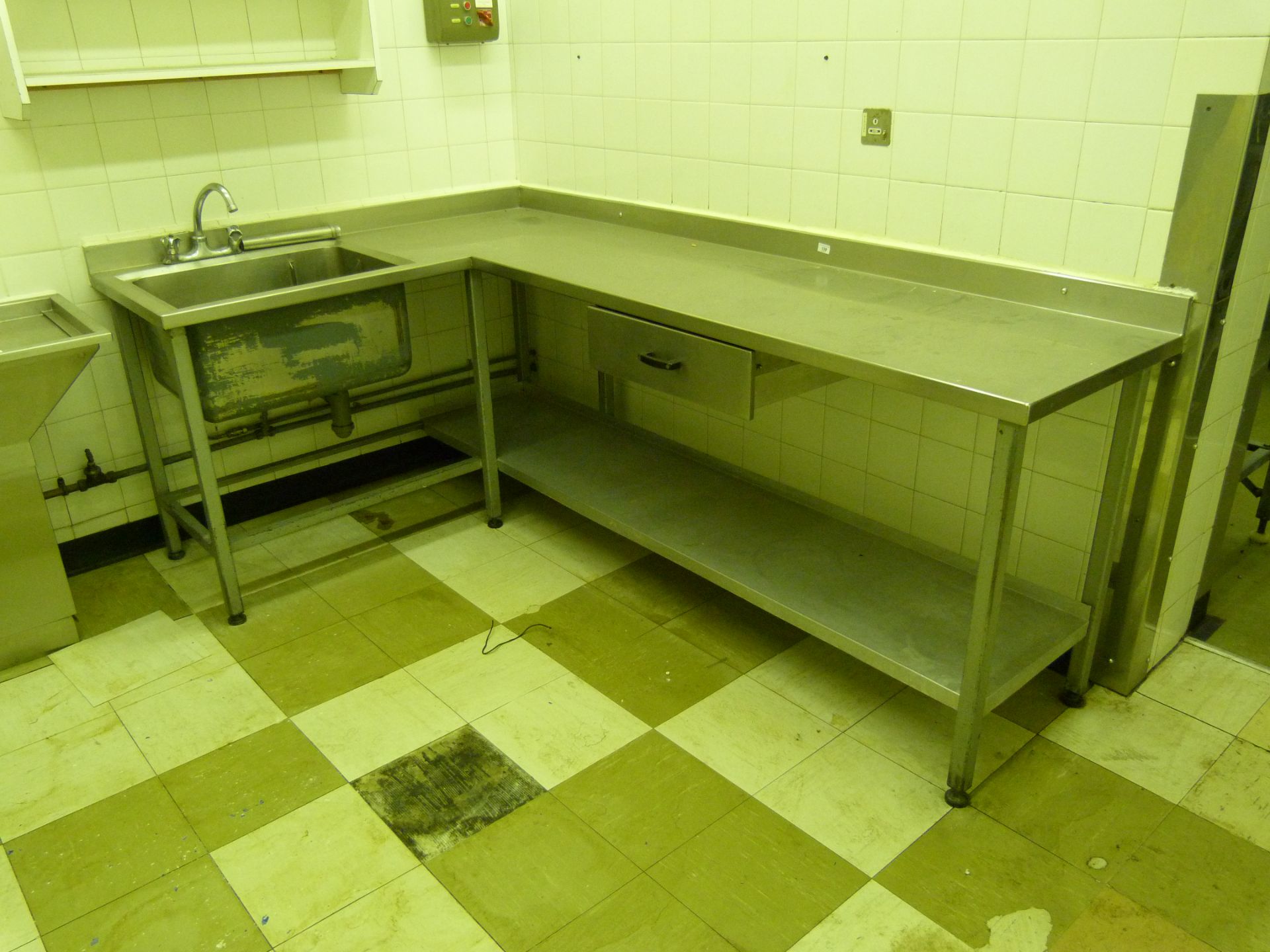 A steel framed stainless steel topped preparation table with sink and drawer 230cm x 146cm x 60cm
