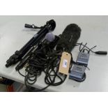 A collection of microphones wireless transmitters and a tripod