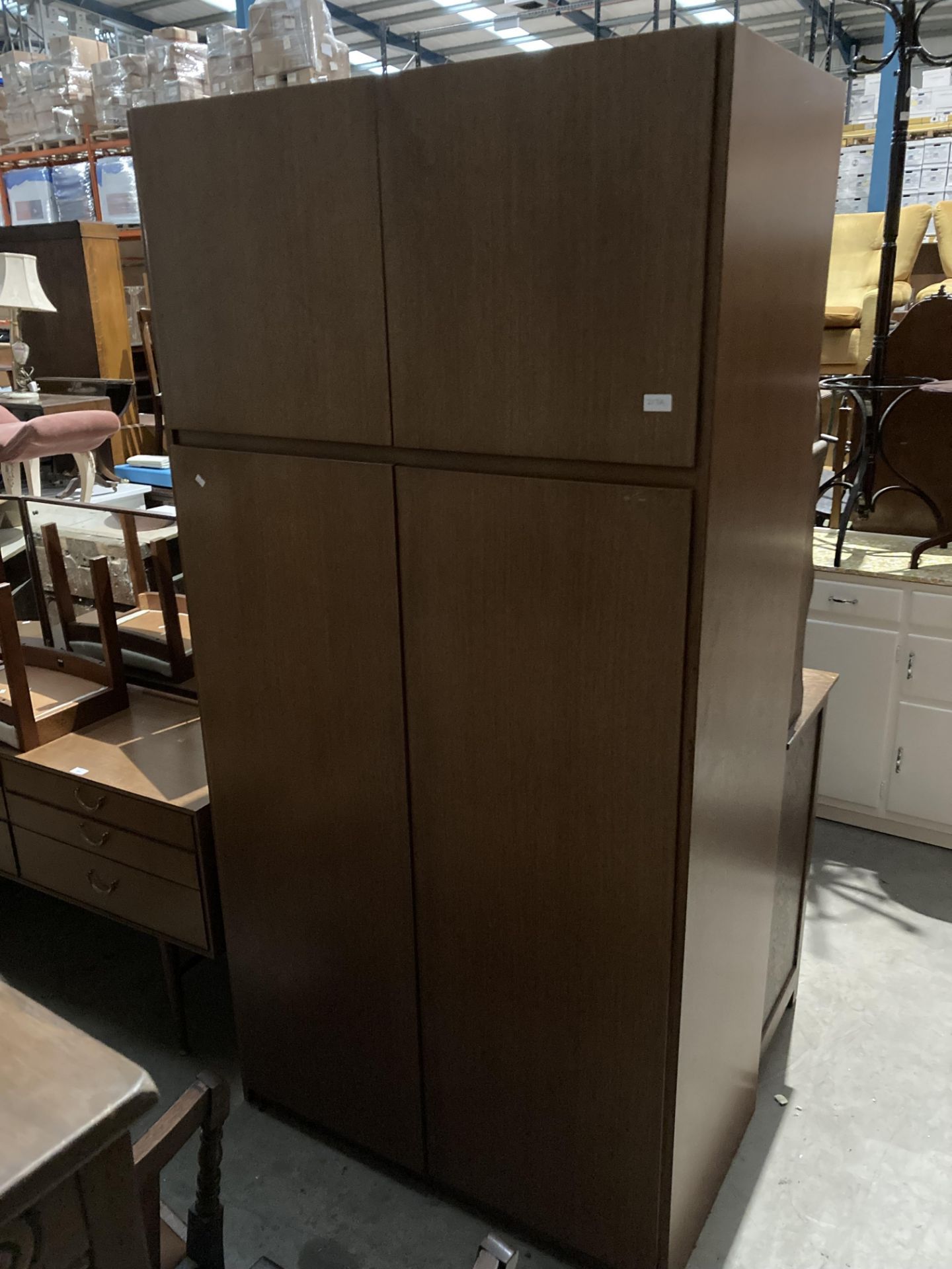 A teak two door wardrobe with two door top box by Meredew,