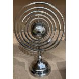 A chrome table standing revolving globe 43cm high.