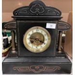 A Victorian black slate mantel clock with brass columns 32cm high x 31cm long - no key