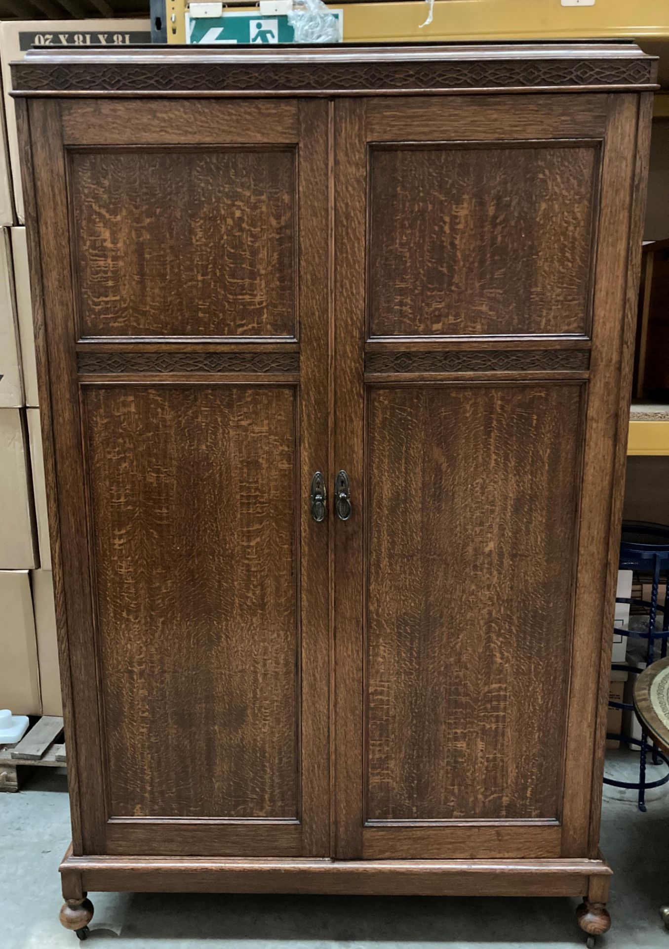 An oak two door wardrobe with fitted eight drawers to the interior - one bun foot detached but in a